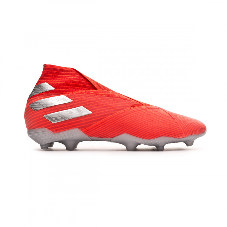 silver and red football boots
