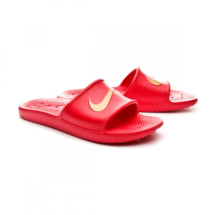 red and gold nike flip flops