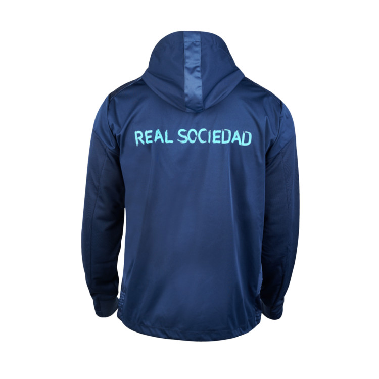 chaqueta-macron-real-sociedad-de-futbol-pre-match-2022-2023-nino-1