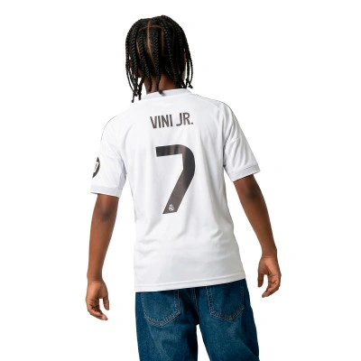 Camisola Real Madrid Primeiro Equipamento 2025-2026 Criança Vini jr + Emblema